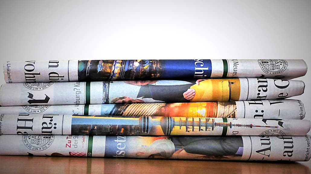 Replace this stack of newspapers with a news app on your phone