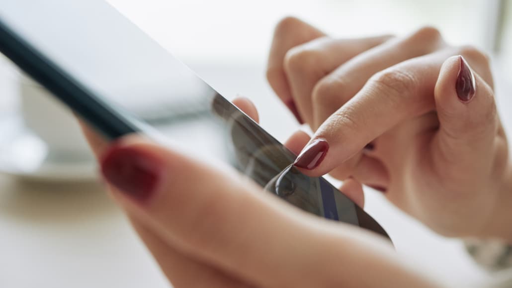 Typing on a smartphone - a language translation service can help with communications