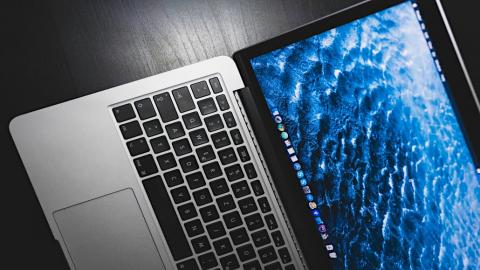 Apple MacBook with blue wallpaper: Access hidden apps on the Mac's disk