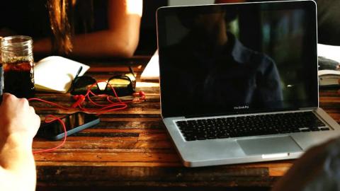 Apple MacBook laptop computer on a table in sleep mode