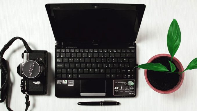 Laptop computer and camera on a desk. Are the files on the laptop backed up?