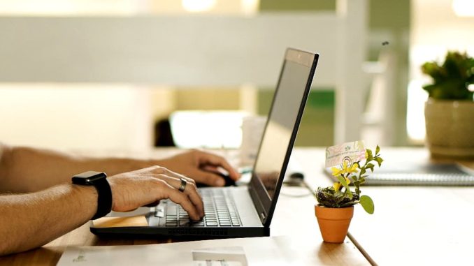 Typing on a laptop computer