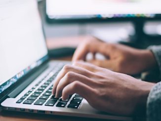 Typing on a laptop computer and accessing the internet