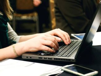 Woman typing on a laptop computer