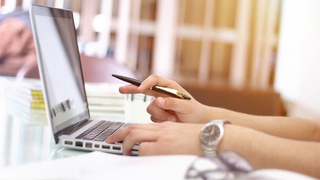 Someone typing on a laptop computer.