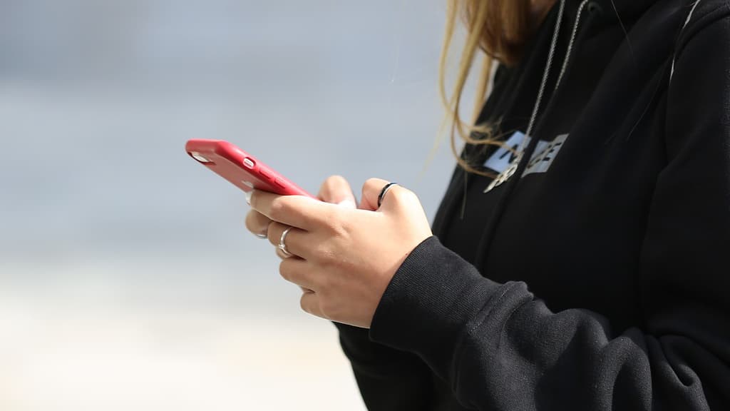 A woman using a mobile phone.