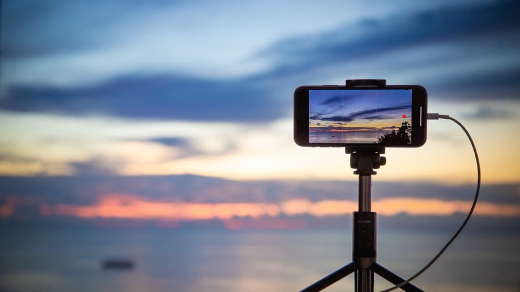 Taking a photo of a sunset with a phone.