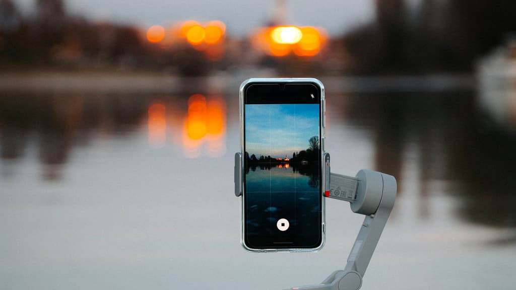 Mobile phone taking a sunset photo.