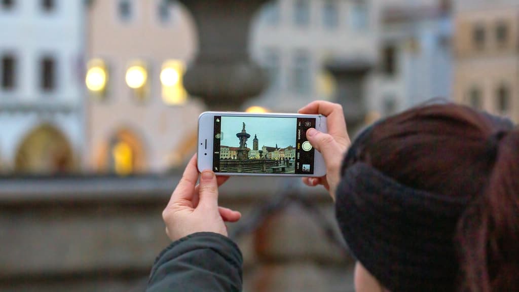 Person taking a photograph with a phone.